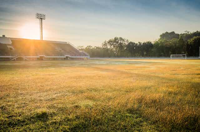 sun setting over a sports field