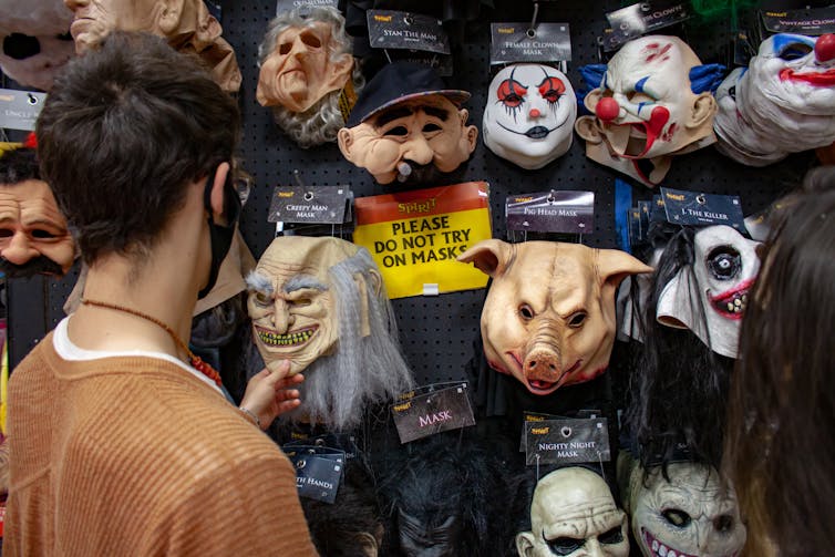 Man looks at masks