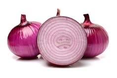 Red onion cut in half revealing red layers.