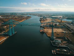 An aerial shot of an industrial area on the river tees, with a blue bridge in the foreground.