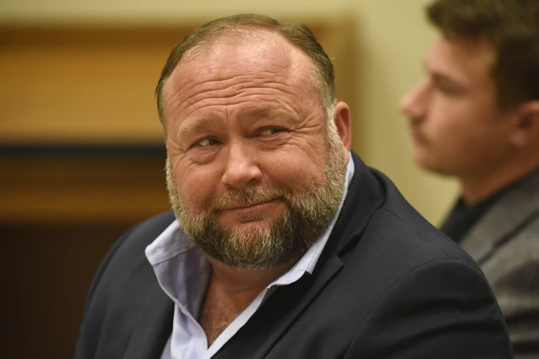 A large man with a big, bearded face, smiles.