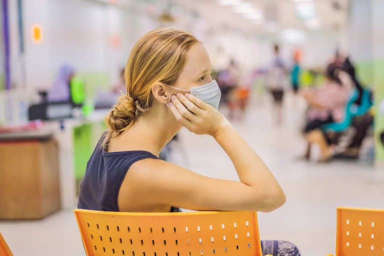 Woman sits in a waiting room