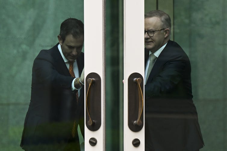 two men push open doors