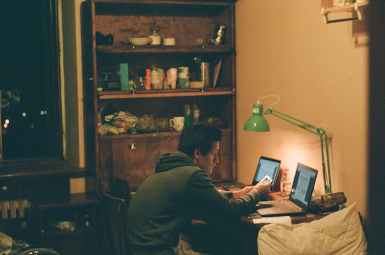Young man' studying on his own at night.