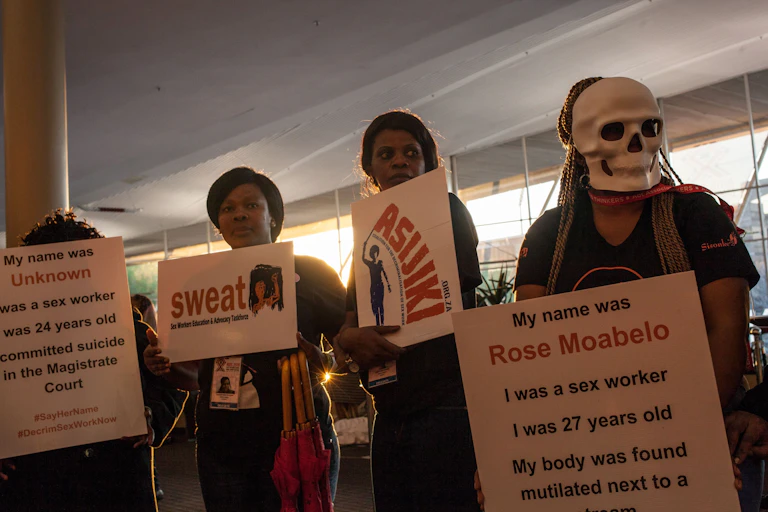 Activists hold placards as they call for the legalisation of prostitution.