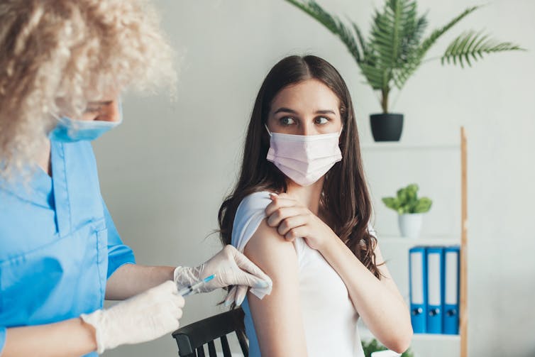 A young woman received a vaccination.