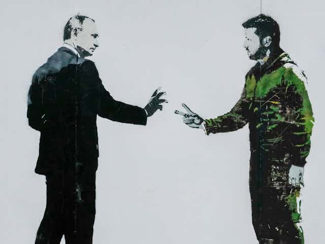 A stencil painting shows two men, one ina suit the other in casual clothes.