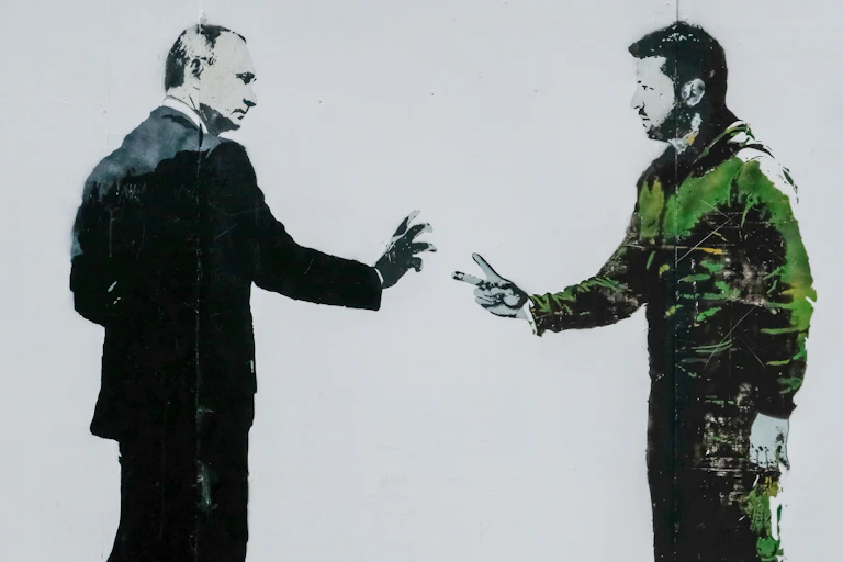 A stencil painting shows two men, one ina suit the other in casual clothes.