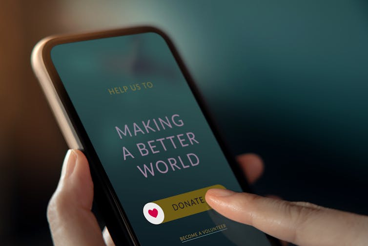 Words on a smartphone screen read: Making a better world.