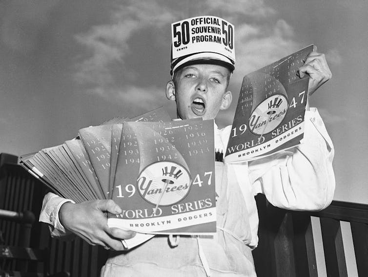 Boy hawking souvenir programs.