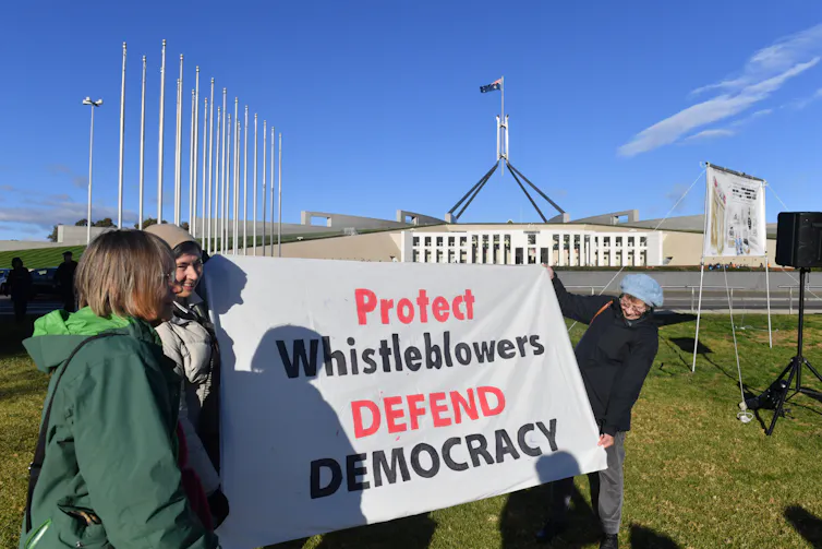 Protesters outside parliament house demand whistleblower protections.