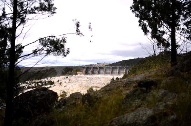 Rough water near a dam, behind bushland