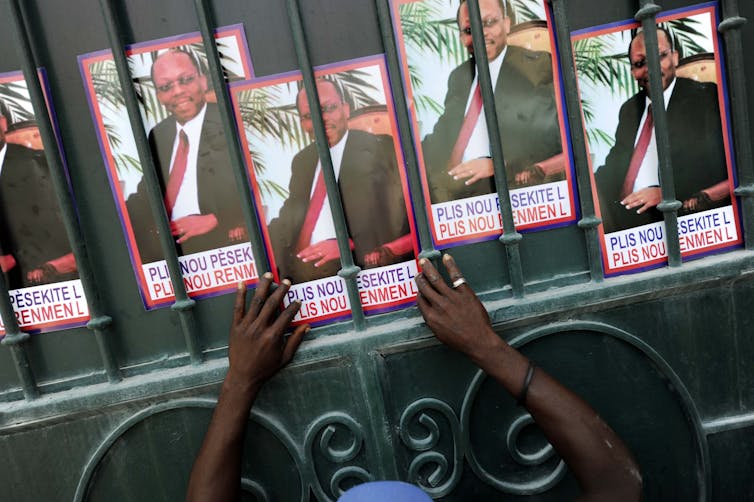 Posters of former Haitian leader Jean-Bertrand Aristide