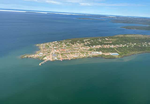 A aerial view of a piece of land surrounded by a lake.