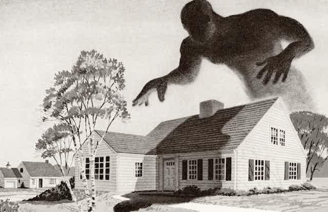 A ghoulish monster hovers above a house.