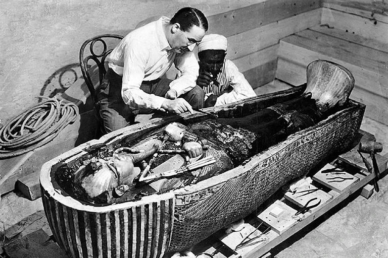 Howard Carter, Ahmed Gerigar and King Tutankhamun's sarcophagus, opened three years after the tomb was discovered, in 1925.