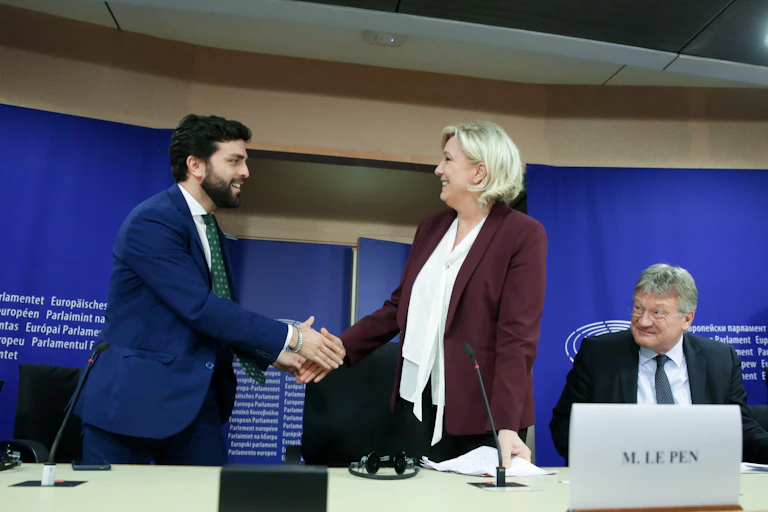 Marco Zanni of Lega shakes hands with the RN's Marine Le Pen in Brussels in 2013.