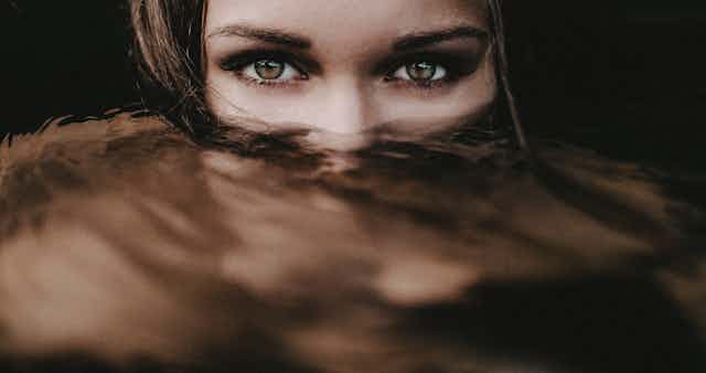 a woman's eyes over murky water