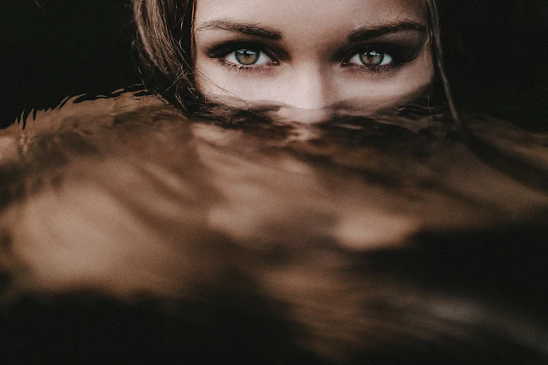 a woman's eyes over murky water