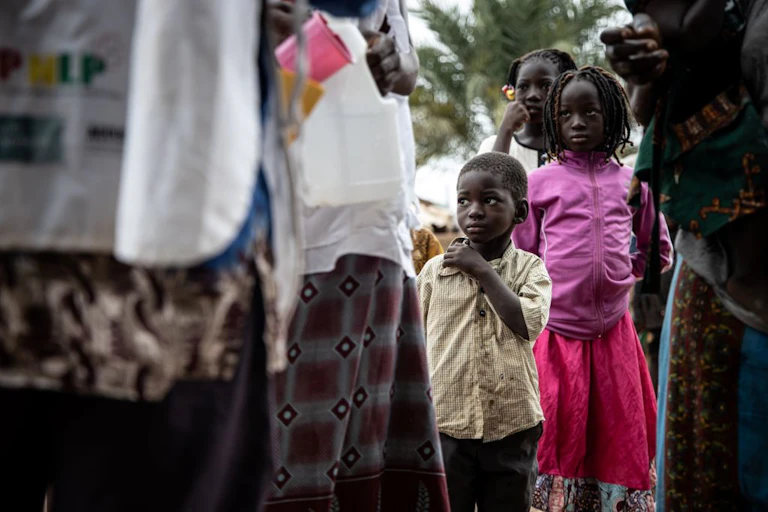 A child looks at the community health workers