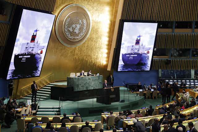 An image of 'Brave Commander,' the first ship to sail from Ukraine to the horn of Africa carrying grain supplies, appears on screen at the UN General Assembly meeting in September 2022.