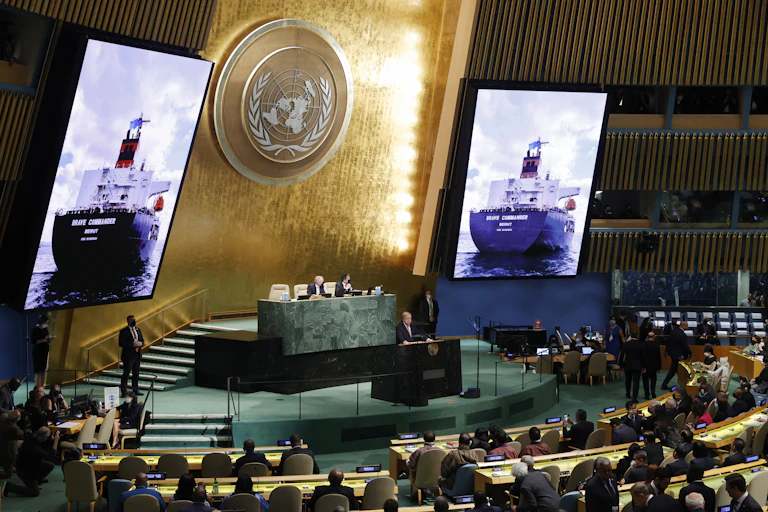 An image of 'Brave Commander,' the first ship to sail from Ukraine to the horn of Africa carrying grain supplies, appears on screen at the UN General Assembly meeting in September 2022.