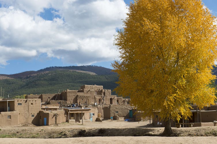 Adobe homes with mountains in the background