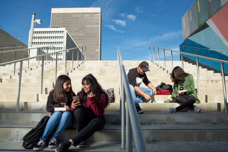 Students seen congregating on steps in dicussion.
