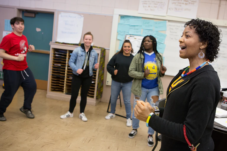 A teacher seen leading a movement high school class.