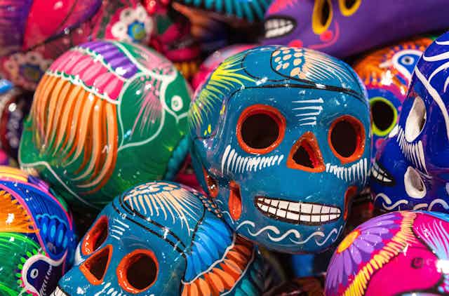 A pile of colourful Day of the Dead skulls.