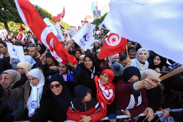 People attend a rally in Tunis to mark the anniversary of the Arab Spring.