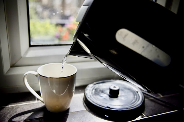 water pours from kettle into mug