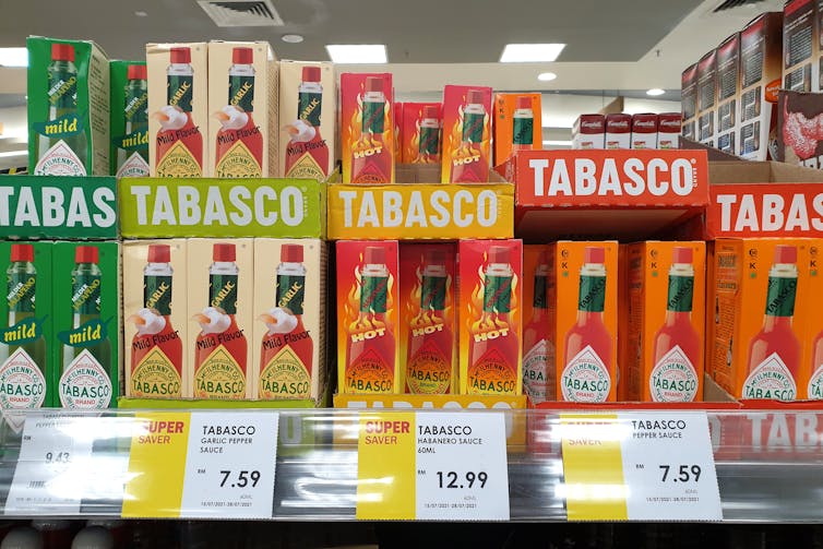 rows of Tabasco hot sauce varieties on a supermarket shelf
