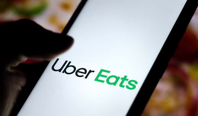 Uber Eats app logo visible on a phone screen