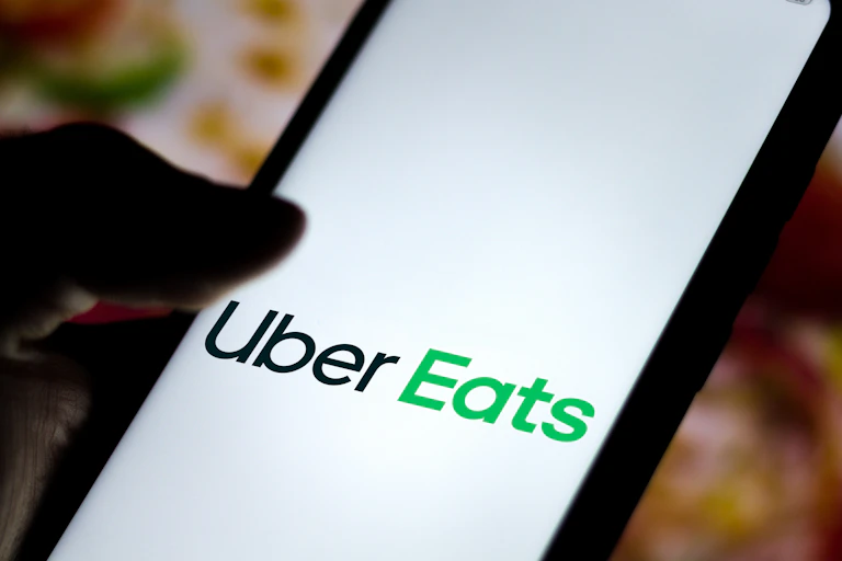 Uber Eats app logo visible on a phone screen