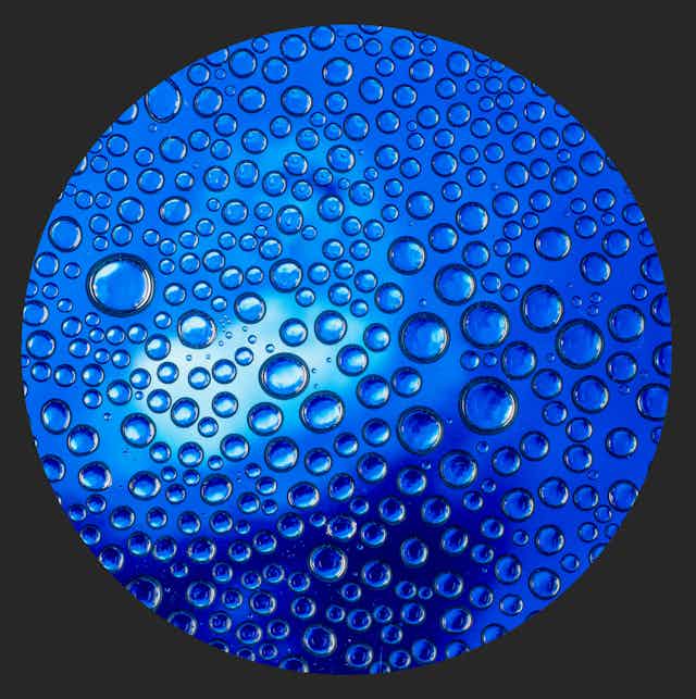 Close up of water molecules against a dark blue background