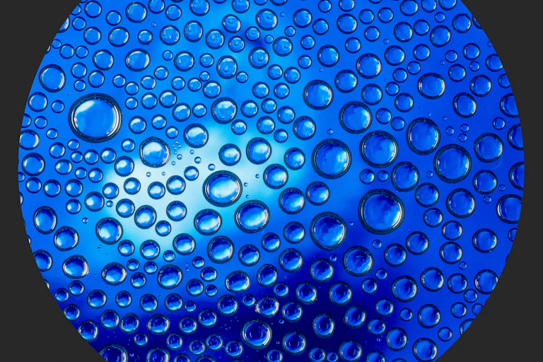 Close up of water molecules against a dark blue background