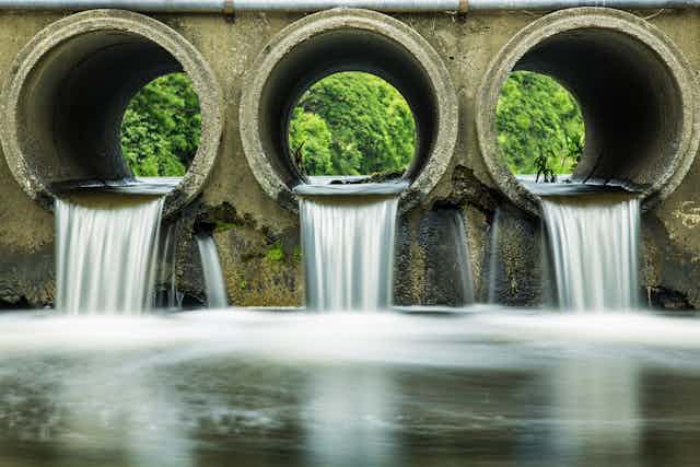 water flowing from three large pipes