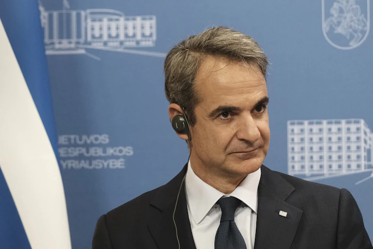 Kyriakos Mitsotakis wearing an earpiece at a press conference