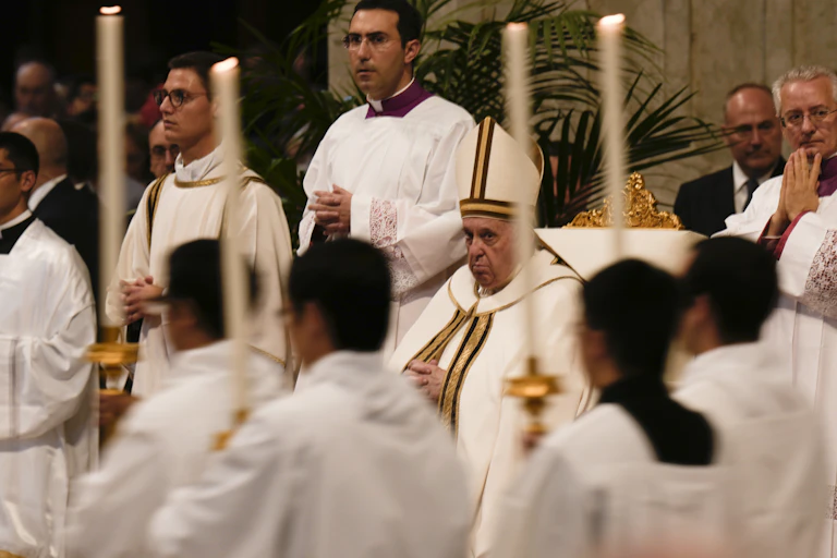Pope Francis looks at the procession arriving for a Mass in St. Peter's Basilica at the Vatican, Tuesday, Oct. 11, 2022.