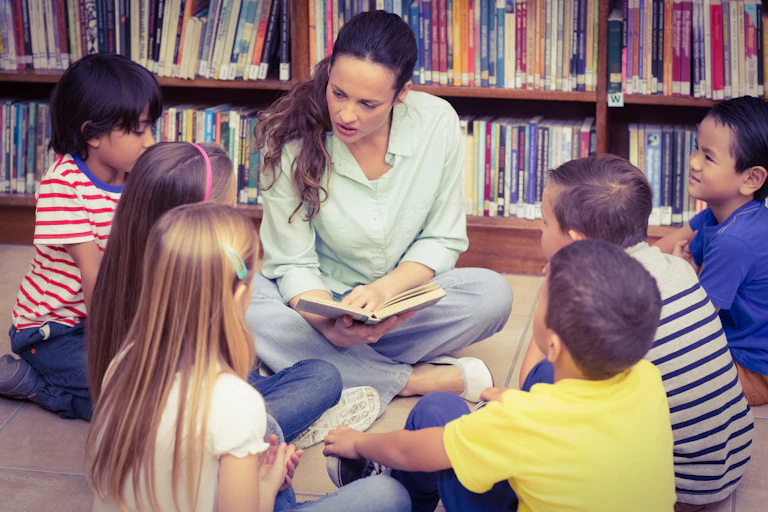 Woman in library reading story to children