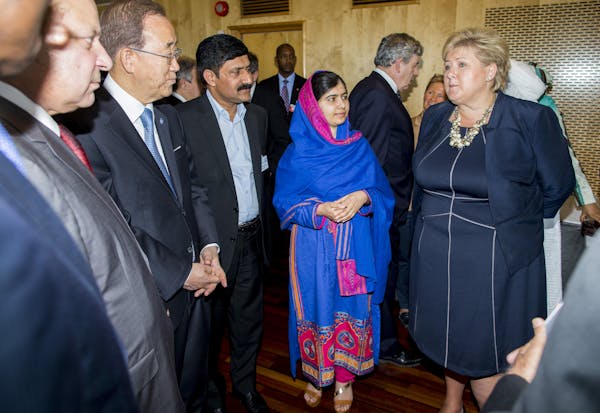 Group of people with girl in blue scarf in centre