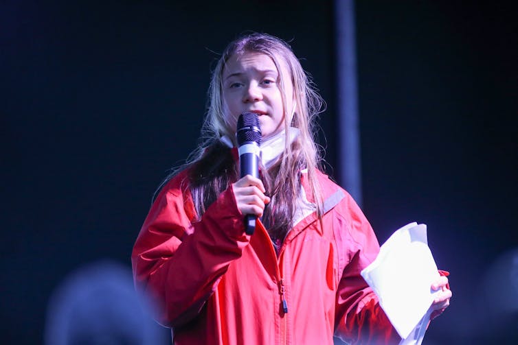 Teenage girl holding microphone