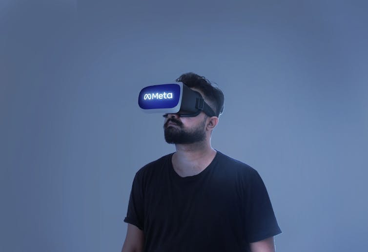 Man wearing VR googles with the Meta logo