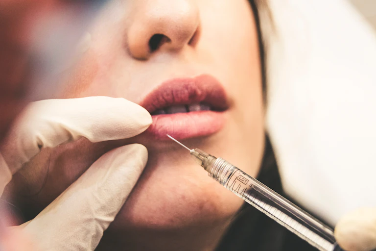 Needle going into woman's lip