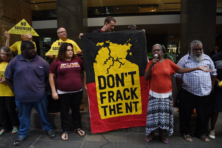 people stand with sign reading 'don't frack the NT'