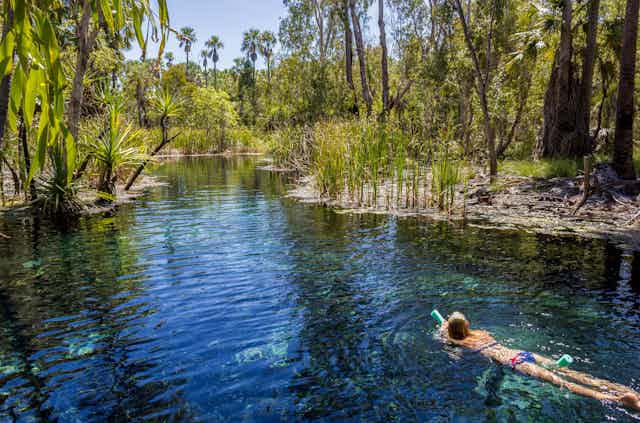 woman swims in thermal spring