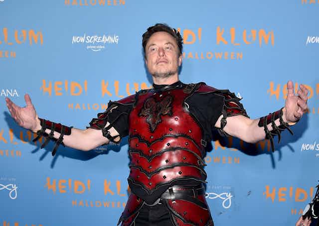 Elon Musk in costume, posing on the red carpet for Heidi Klum's birthday party.