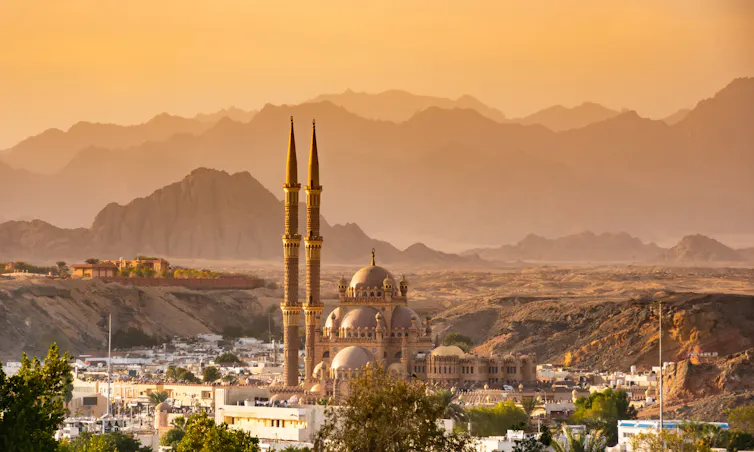 Large mosque with mountains in background