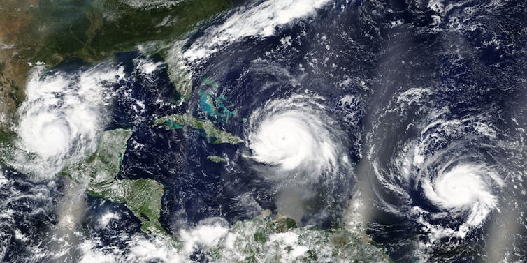 Satellite image of three hurricanes in Gulf of Mexico and Caribbean